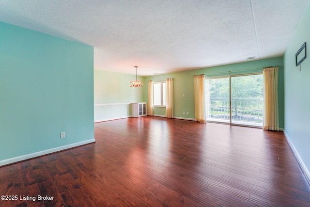 5100 US Highway 42 Unit 226, Louisville, KY 40241 - empty room featuring a textured ceiling, wood finished floors, a chandelier, and baseboards