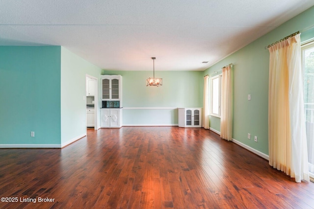 5100 US Highway 42 Unit 226, Louisville, KY 40241 - unfurnished living room featuring a chandelier, dark wood finished floors, healthy amount of natural light, and baseboards