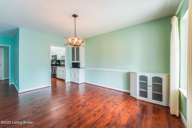 5100 US Highway 42 Unit 226, Louisville, KY 40241 - unfurnished dining area featuring a chandelier, dark wood-style flooring, and baseboards