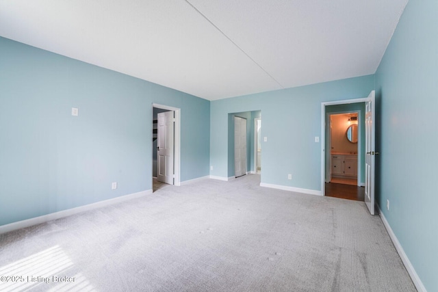 5100 US Highway 42 Unit 226, Louisville, KY 40241 - unfurnished bedroom featuring light colored carpet, ensuite bath, and baseboards