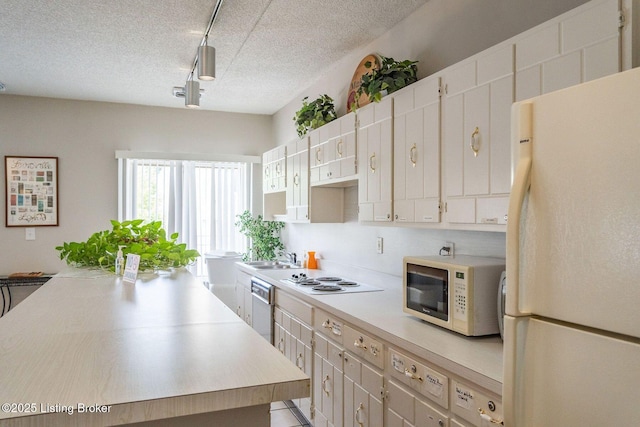 5100 US Highway 42 Unit 226, Louisville, KY 40241 - kitchen featuring white appliances, light countertops, a textured ceiling, track lighting, and a sink