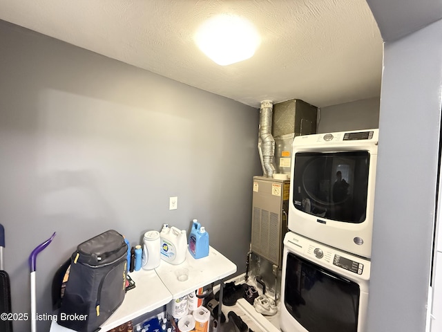 laundry area with stacked washer and clothes dryer and laundry area