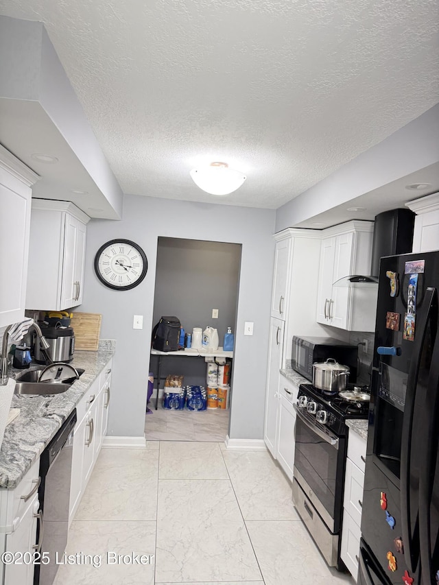 kitchen featuring a sink, white cabinetry, and black appliances