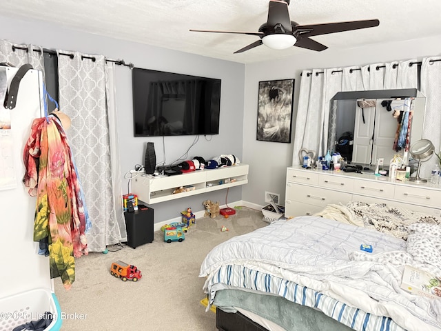 carpeted bedroom featuring a ceiling fan and baseboards