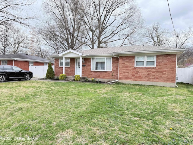 ranch-style house featuring brick siding, a front lawn, and fence