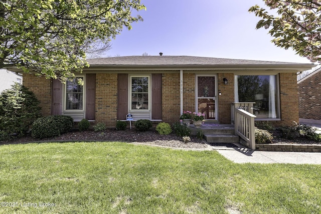 ranch-style house featuring brick siding and a front yard