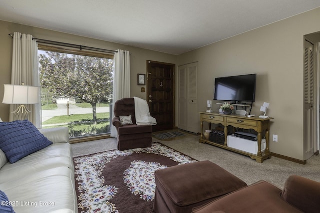 living room with baseboards and carpet