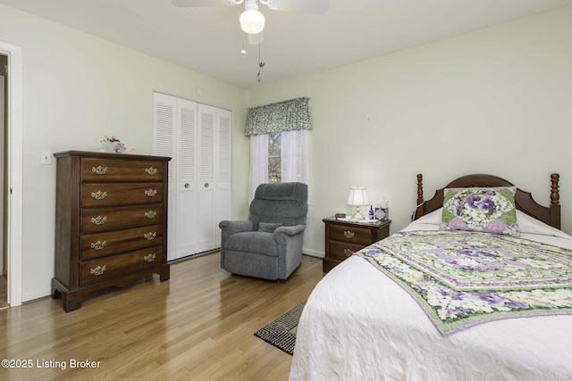 bedroom with a ceiling fan, baseboards, light wood-style floors, and a closet