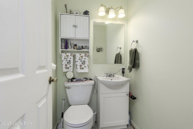 half bathroom featuring toilet and vanity