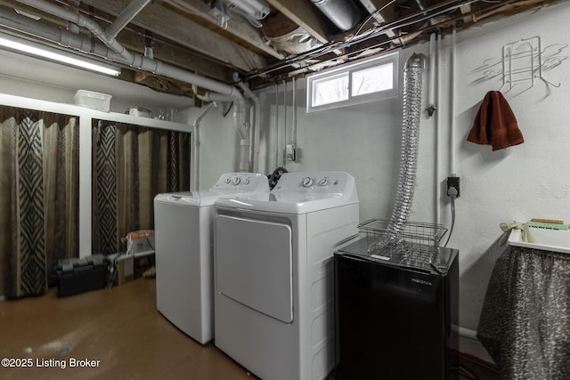 clothes washing area with washing machine and dryer and laundry area