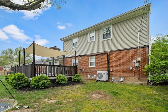 rear view of property with a wooden deck, a lawn, ac unit, and brick siding