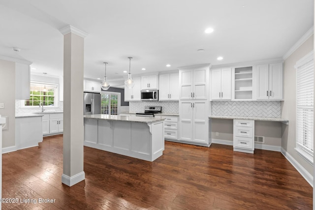 kitchen featuring backsplash, appliances with stainless steel finishes, a sink, and white cabinets