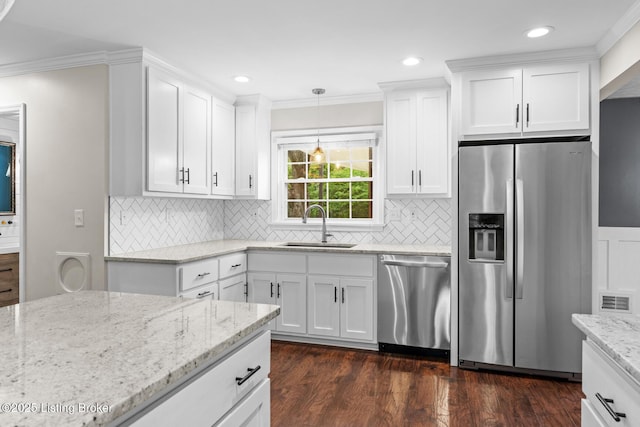 kitchen featuring stainless steel appliances, a sink, dark wood finished floors, white cabinetry, and light stone countertops