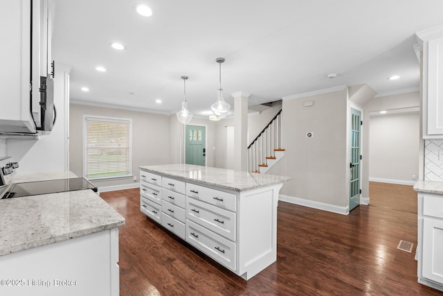 kitchen with electric range, baseboards, ornamental molding, and recessed lighting