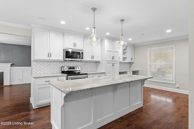 kitchen featuring appliances with stainless steel finishes, crown molding, and white cabinetry