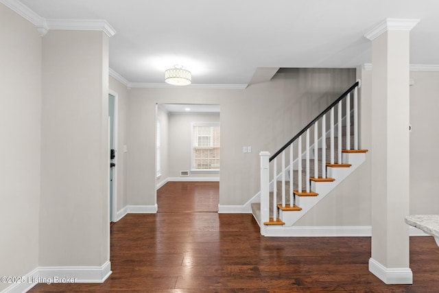 entrance foyer with hardwood / wood-style flooring, baseboards, stairway, and crown molding