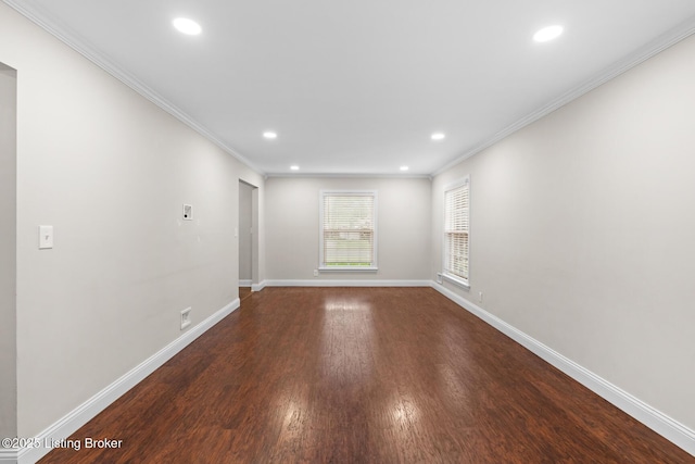 empty room featuring baseboards, ornamental molding, wood finished floors, and recessed lighting