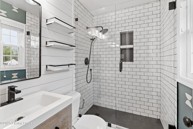 full bathroom featuring vanity, toilet, and a stall shower