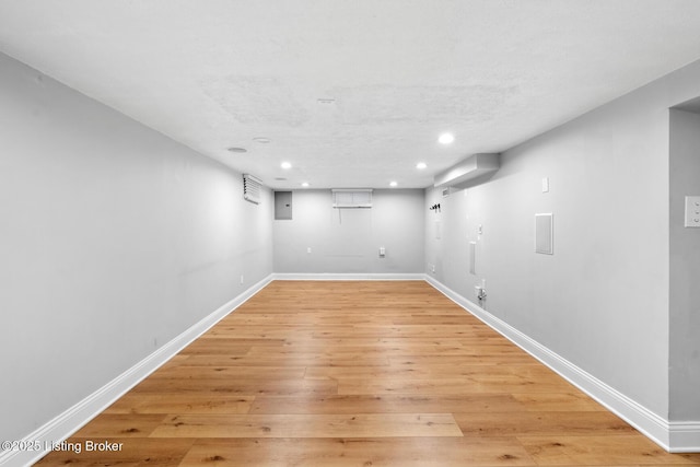 finished basement featuring baseboards, light wood finished floors, and recessed lighting