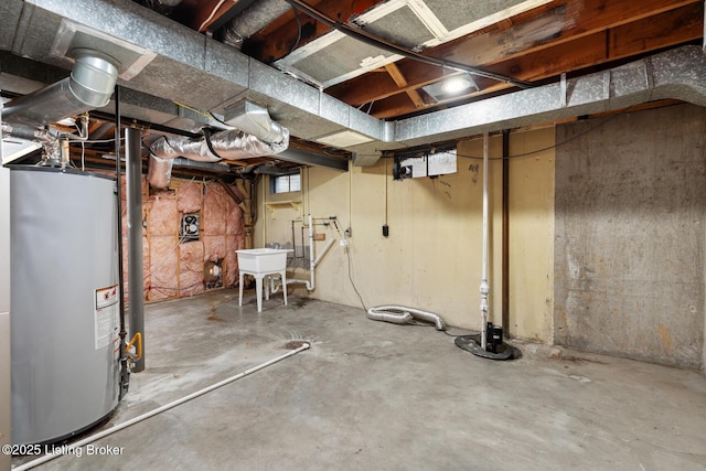 unfinished below grade area featuring gas water heater and a sink