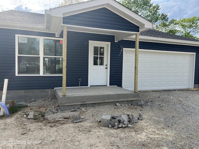 ranch-style home with an attached garage, driveway, and a shingled roof