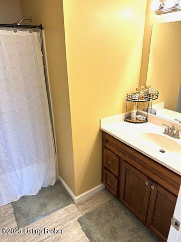 full bathroom featuring a shower with shower curtain and vanity