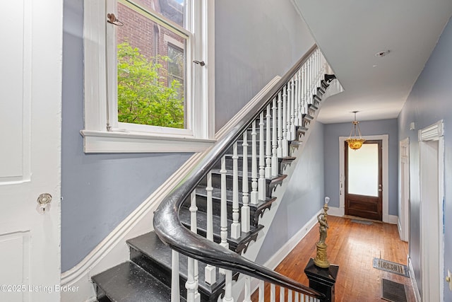 1206 S 6th St, Louisville, KY 40203 - staircase featuring visible vents, baseboards, and wood finished floors