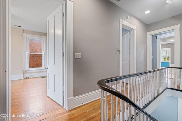 1206 S 6th St, Louisville, KY 40203 - hallway featuring light wood-style flooring, baseboards, and an upstairs landing