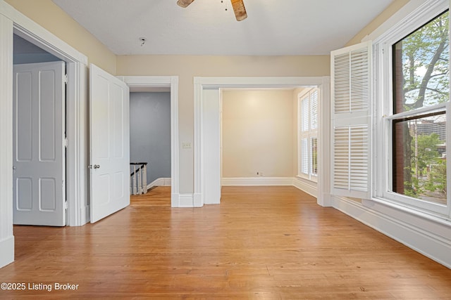 1206 S 6th St, Louisville, KY 40203 - unfurnished bedroom with light wood-style flooring, baseboards, and multiple windows