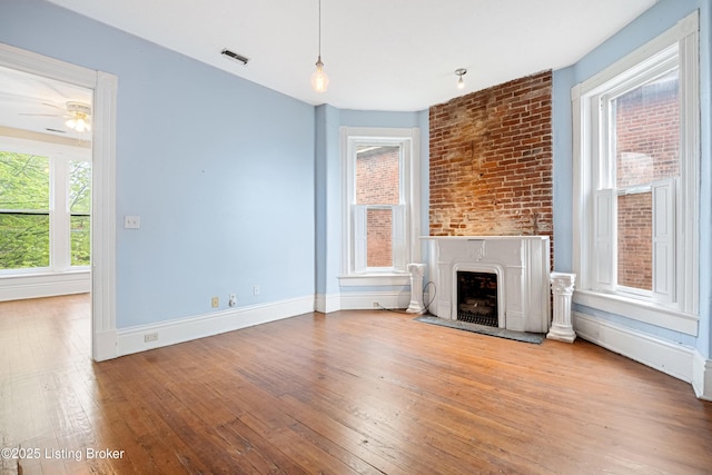 1206 S 6th St, Louisville, KY 40203 - unfurnished living room featuring hardwood / wood-style floors, visible vents, baseboards, a fireplace, and ceiling fan