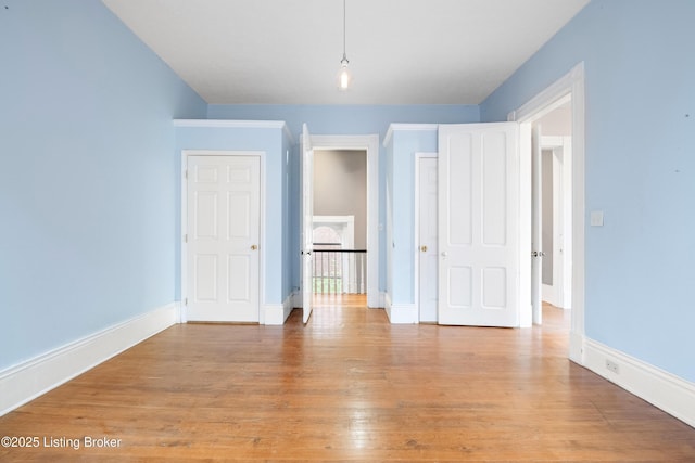 1206 S 6th St, Louisville, KY 40203 - unfurnished bedroom with wood finished floors and baseboards