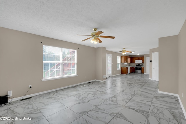 unfurnished living room featuring visible vents, marble finish floor, baseboards, and a ceiling fan