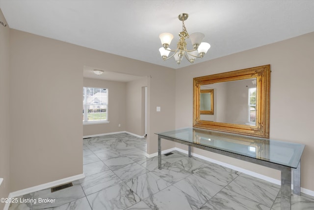 interior space featuring marble finish floor, baseboards, visible vents, and an inviting chandelier