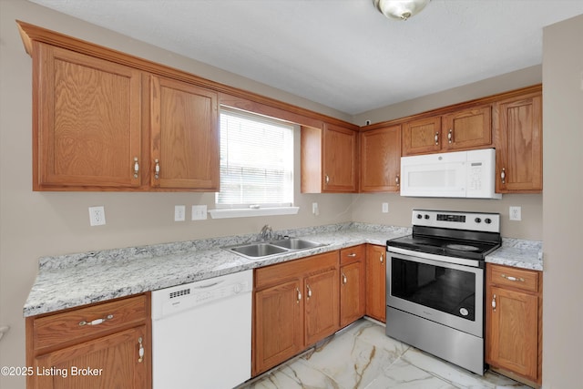 kitchen featuring light countertops, white appliances, a sink, and marble finish floor