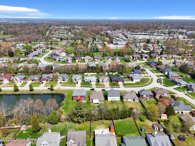 drone / aerial view featuring a water view and a residential view