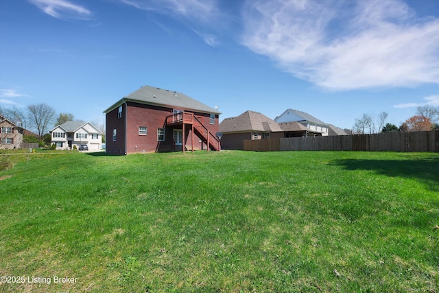 view of yard featuring stairs, fence, and a deck