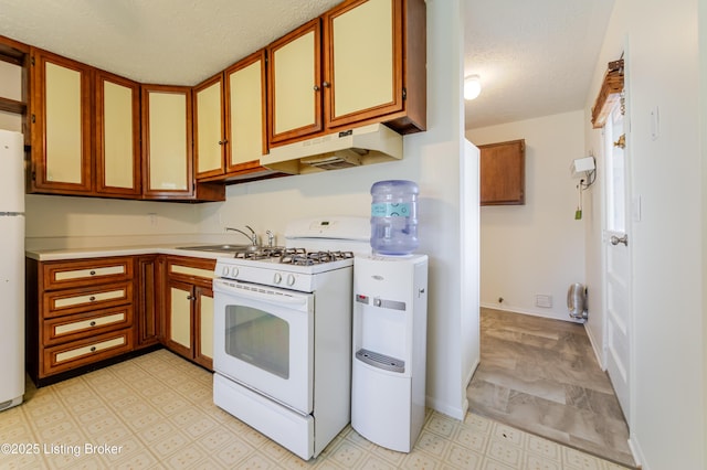 215 Bottorff Dr, Sellersburg, IN 47172 - kitchen with a textured ceiling, a sink, white appliances, light floors, and under cabinet range hood