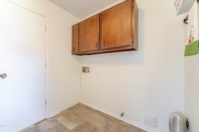 215 Bottorff Dr, Sellersburg, IN 47172 - clothes washing area featuring baseboards, cabinet space, a textured ceiling, and washer hookup