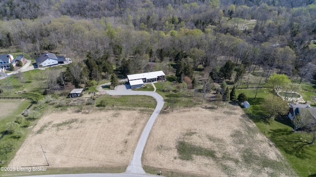 drone / aerial view featuring a forest view