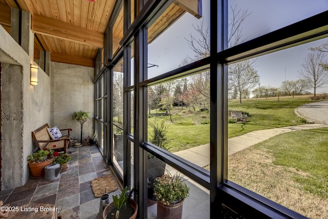 sunroom with beamed ceiling and a wealth of natural light
