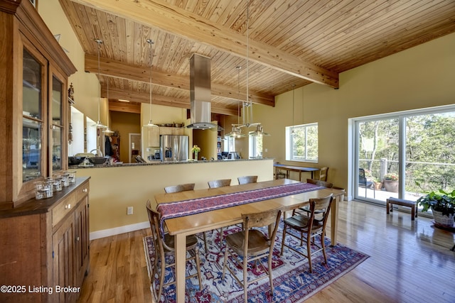 dining room with wooden ceiling, wood-type flooring, and beamed ceiling