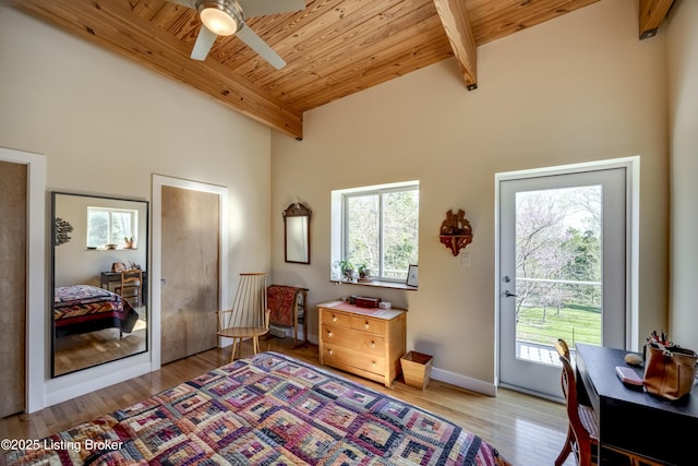 interior space featuring beamed ceiling, wood finished floors, wooden ceiling, and access to outside