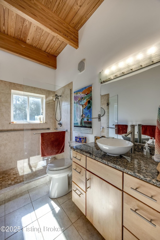 bathroom featuring tile patterned floors, vanity, wood ceiling, toilet, and tiled shower
