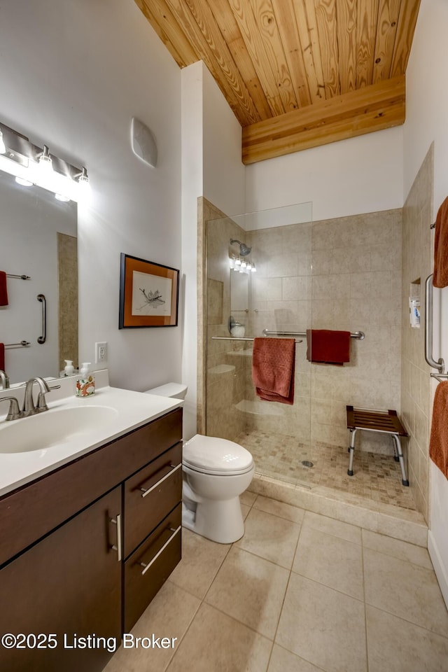 bathroom featuring tile patterned floors, toilet, wooden ceiling, vanity, and a walk in shower
