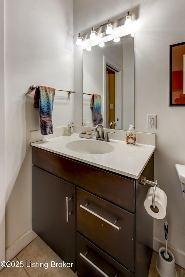 bathroom featuring vanity, tile patterned flooring, and toilet