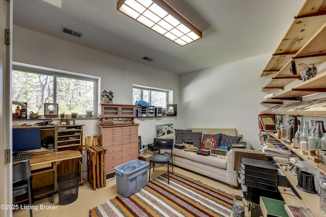 living area featuring finished concrete floors and visible vents