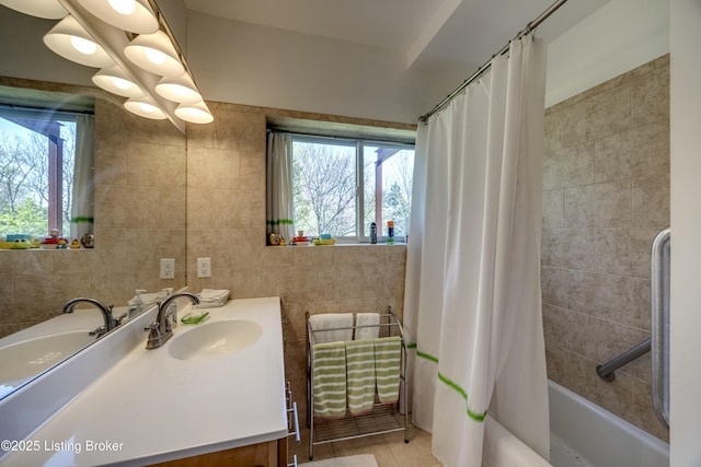 full bathroom featuring tile walls, tile patterned flooring, vanity, and shower / bath combination with curtain