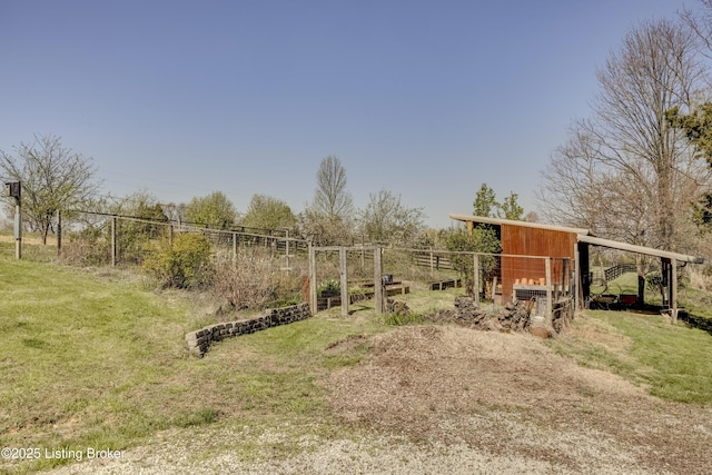 view of yard with fence and an outbuilding