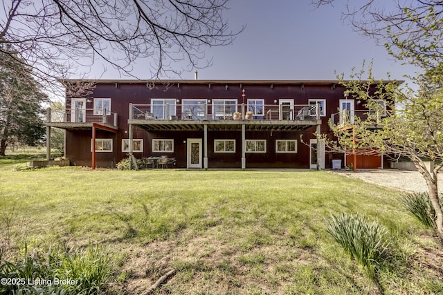 rear view of property with a lawn
