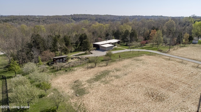 aerial view with a rural view and a wooded view